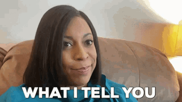 a woman is sitting on a couch with the words what i tell you behind her