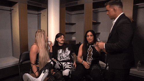 a man in a suit talks to a group of people