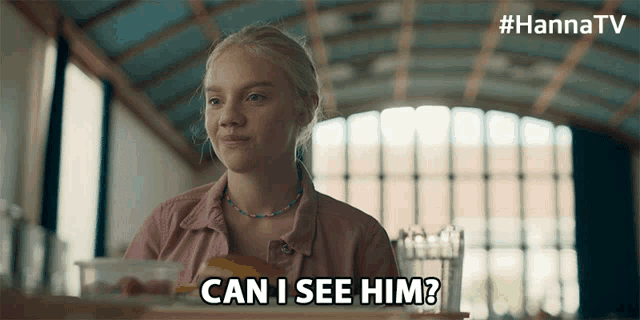 a woman sitting at a table says " can i see him ? "
