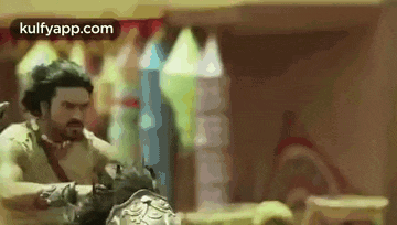 a man in armor is fighting another man in armor in a room .