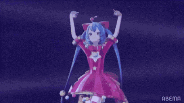 a girl in a pink dress is dancing on a stage with her arms in the air .