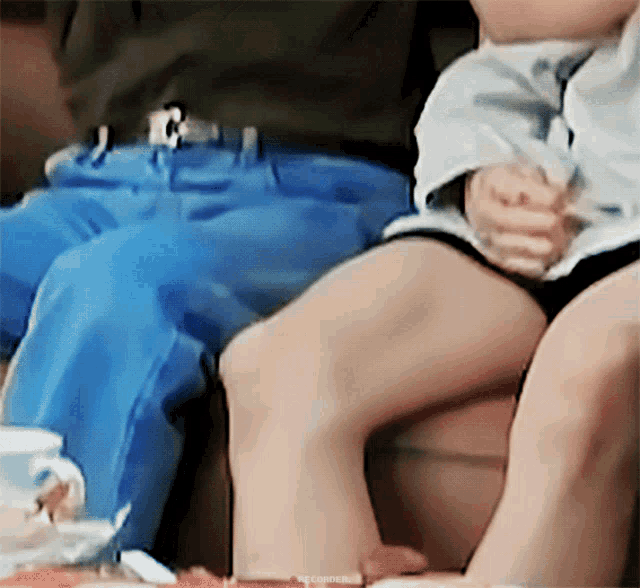 a baby is sitting on a person 's lap with the words recorder written on the bottom