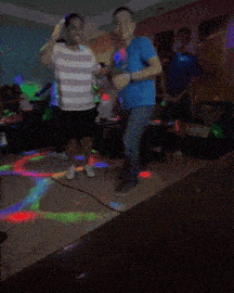 a man in a blue shirt with the letter i on it dancing