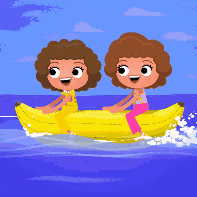 two girls are riding a banana boat in the water
