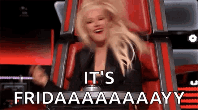 a woman is sitting in a red chair with the words `` it 's friday '' written on her face .