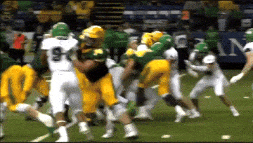 a football player with the number 9 on his jersey is being tackled