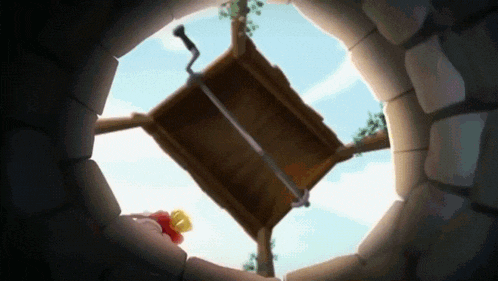 looking up into a well with a wooden box in the middle