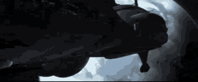a silhouette of a space ship flying through space