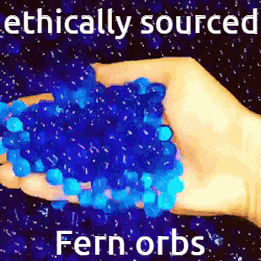 a hand is holding a pile of blue fern orbs in front of a starry background