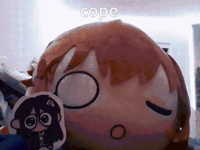 a stuffed doll with a sticker on it that says cope