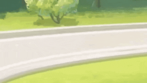 a man is riding a motorcycle down a road and falling off it .