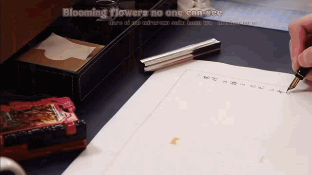 a person is writing on a piece of paper with the words blooming flowers no one can see below them