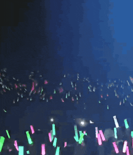 a cartoon character is dancing on a stage surrounded by glow in the dark lights