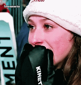 a close up of a woman wearing a glove that says kinetic