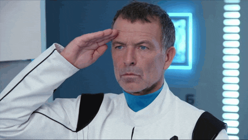 a man in a white and blue uniform salutes