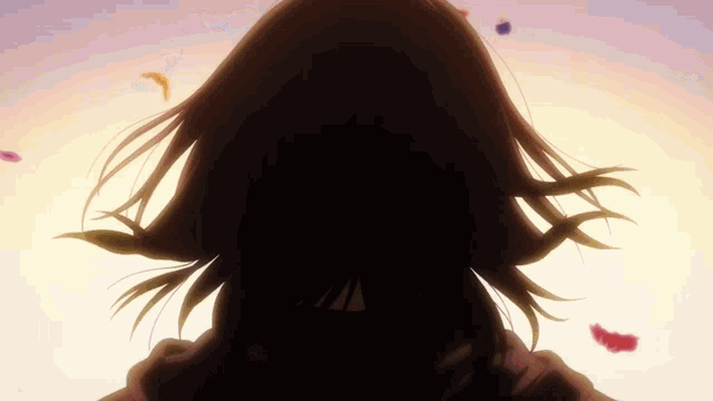 a silhouette of a woman 's face with petals falling from her hair