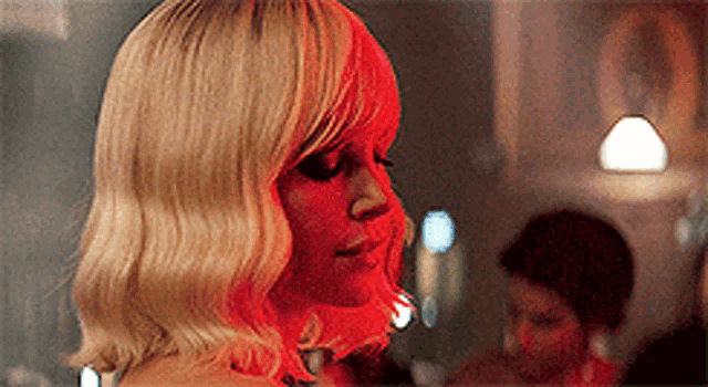 a woman with blonde hair has a red face painted on her face