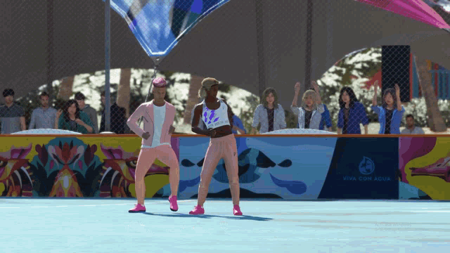 two women in pink dancing in front of a sign that says viva con agua