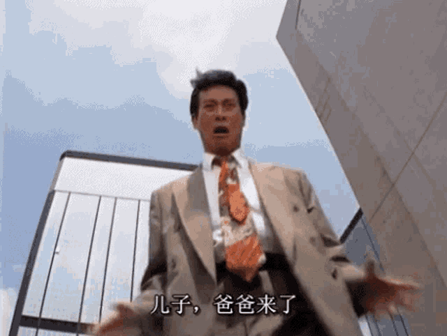 a man in a suit and tie is standing in front of a building in a city .