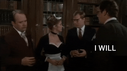 a man in a suit and tie is talking to a woman in a maid costume in a room .
