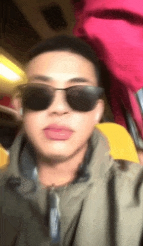 a man wearing sunglasses is taking a selfie