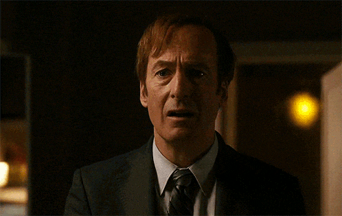 a man in a suit and tie is making a funny face