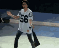 a man wearing a jersey with the number 56 on it is dancing