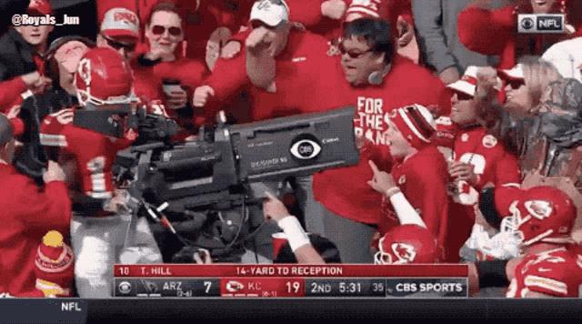 a cbs sports broadcast of a football game with a crowd of fans