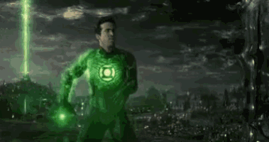 a man in a green lantern costume is holding a green light in his hands .