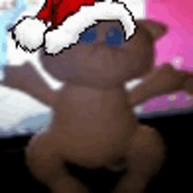 a teddy bear wearing a santa hat is sitting on a table .