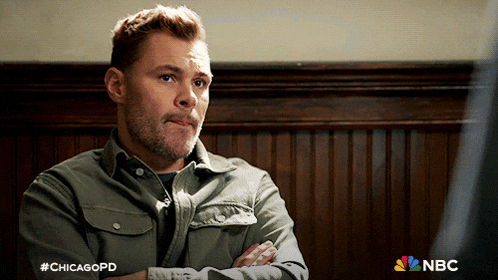 a man with his arms crossed and #chicagopd written on the bottom of his shirt