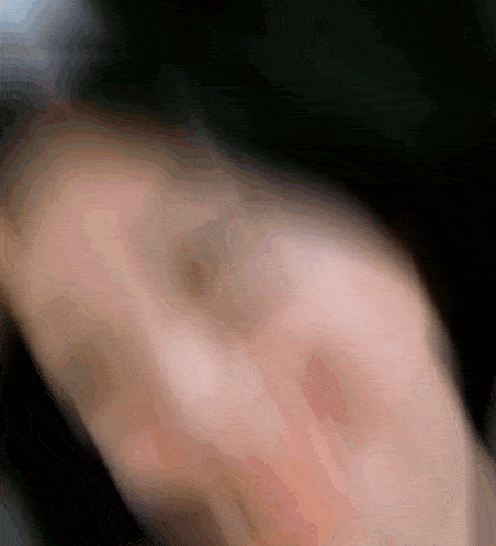a blurred image of a person 's face with a black background