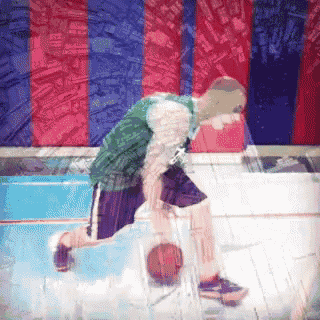 a man dribbles a basketball on a basketball court