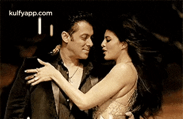 a man and a woman are dancing together in a room .