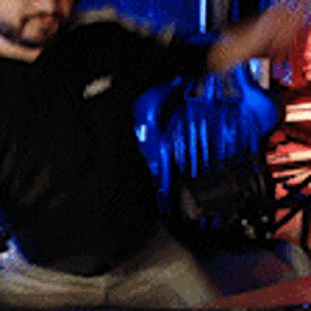 a man with a beard is wearing headphones and pointing at the camera .