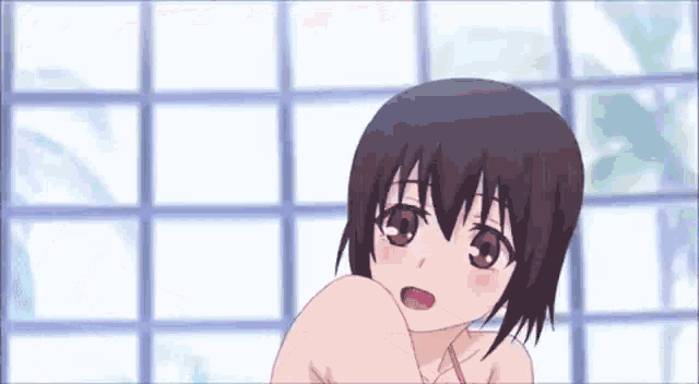a girl in a bikini is sitting in front of a window in a bathroom .