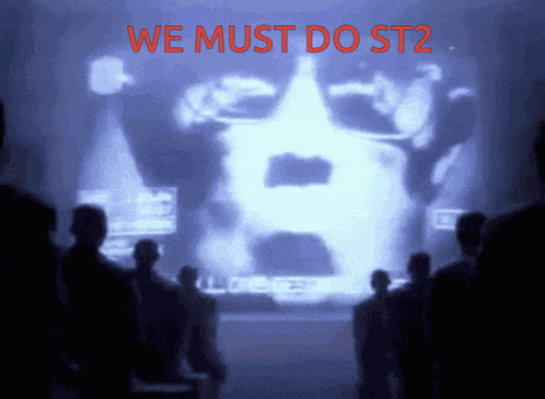 a group of people are looking at a screen that says " we must do st2 "