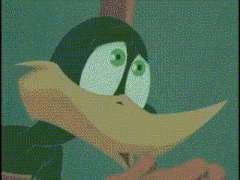 a close up of a cartoon character with green eyes and a red beak .