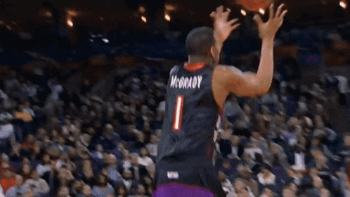 a basketball player wearing a purple toronto jersey