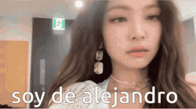 a close up of a woman 's face with the words soy de alejandro written below her