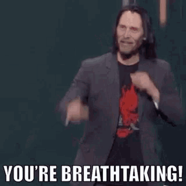 a man in a suit is standing on a stage and making a funny face .