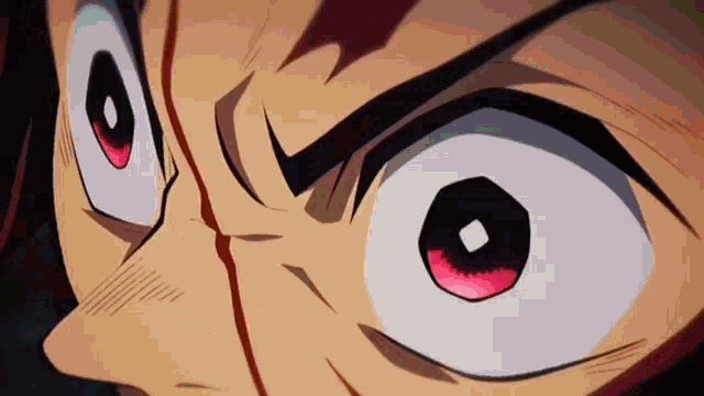 a close up of a person 's eyes with red eyes and a very angry look on their face .
