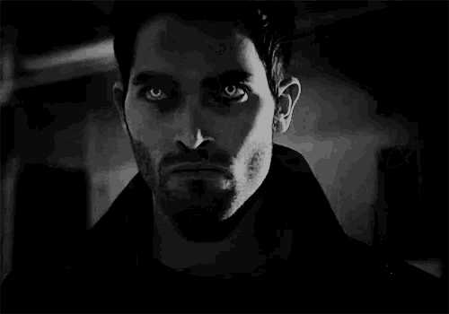 a close up of a man with vampire teeth .
