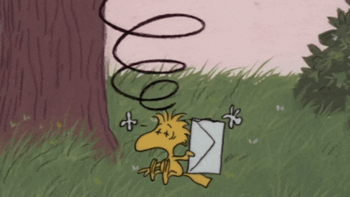 a cartoon of woodstock holding an envelope in a grassy field