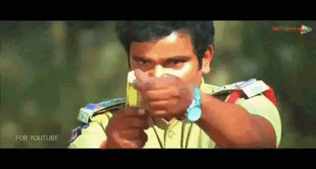 a man in a police uniform is holding a lighter in his hand .