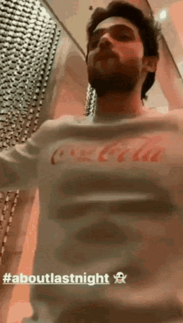 a man in a coca cola shirt is dancing