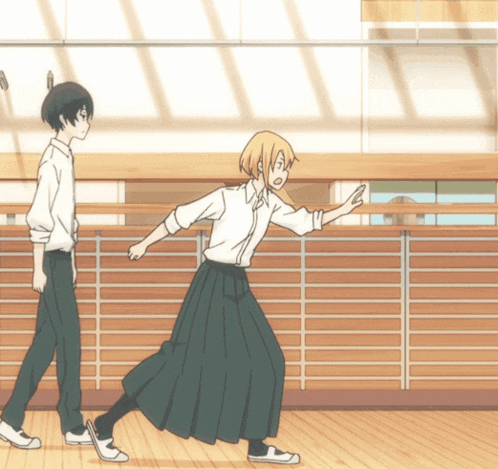 a boy and a girl walking down a hallway
