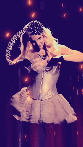 a woman in a white dress and black gloves with a snake on her head