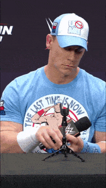 a man wearing a shirt that says " the last time is now "
