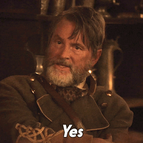a man with a beard and a yes sign